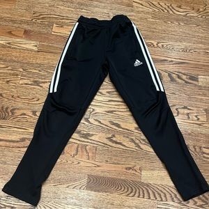 Adidas black joggers with white stripes and side zip pockets and zipper ankles